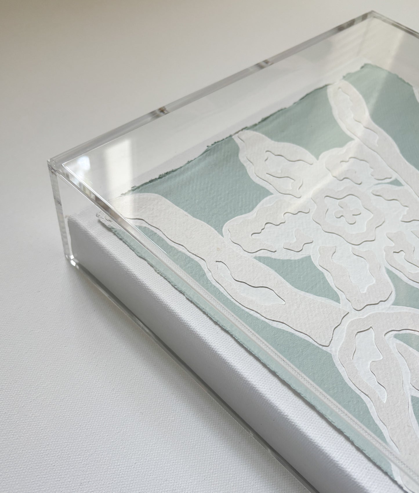 Abstract white floral art by Kendal Blanchard Art on handmade cotton paper, light blue background, in acrylic box frame.