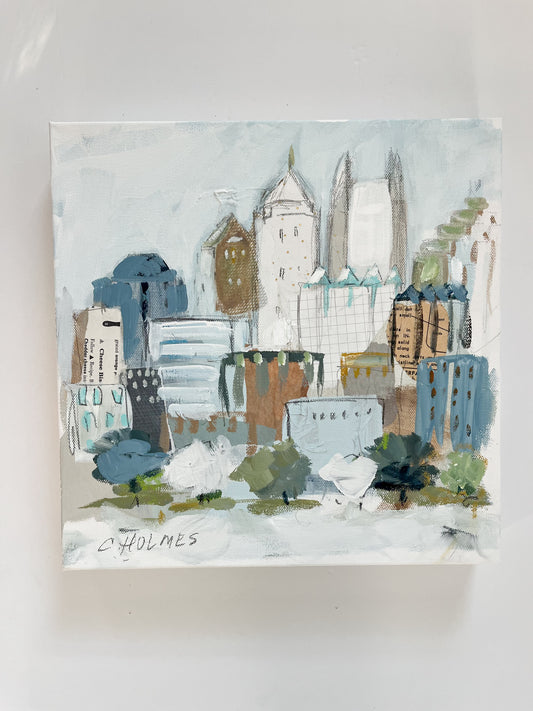 Christy Holmes 12x12 acrylic on canvas features a colorful abstract Atlanta skyline with vibrant buildings and trees.