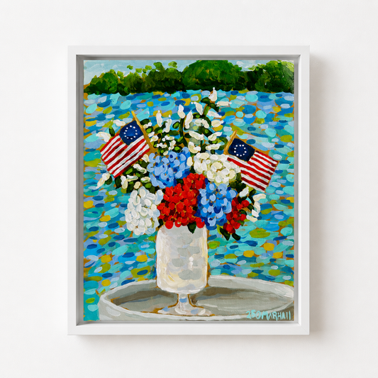 Lauren Marshall Fine Art: A Fourth of July painting of red, white & blue flowers with flags by a lakeside.