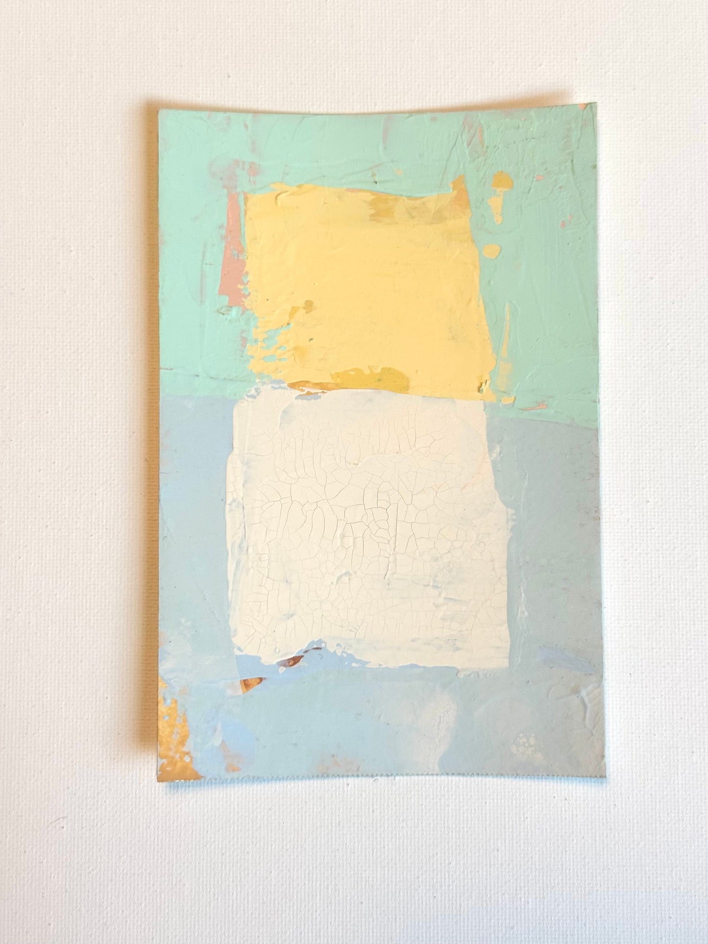 KP Art Collectives minimalist wall art shows a yellow block over white on a sunwashed blue-green background.