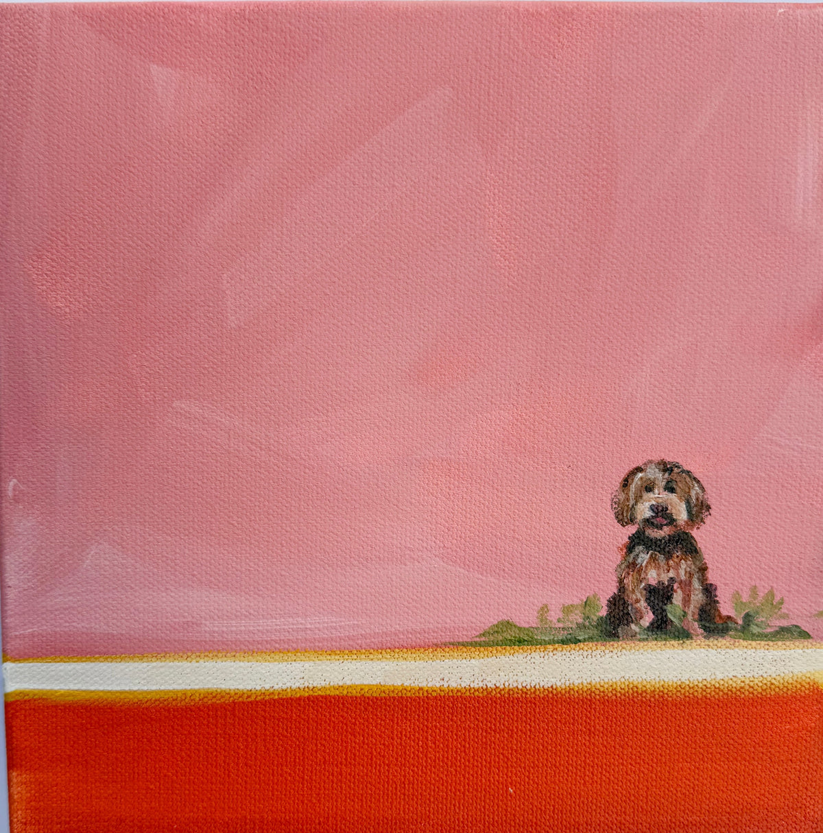 A small, brown and black labradoodle sits in the corner of this original acrylic painting with a pink and orange background.