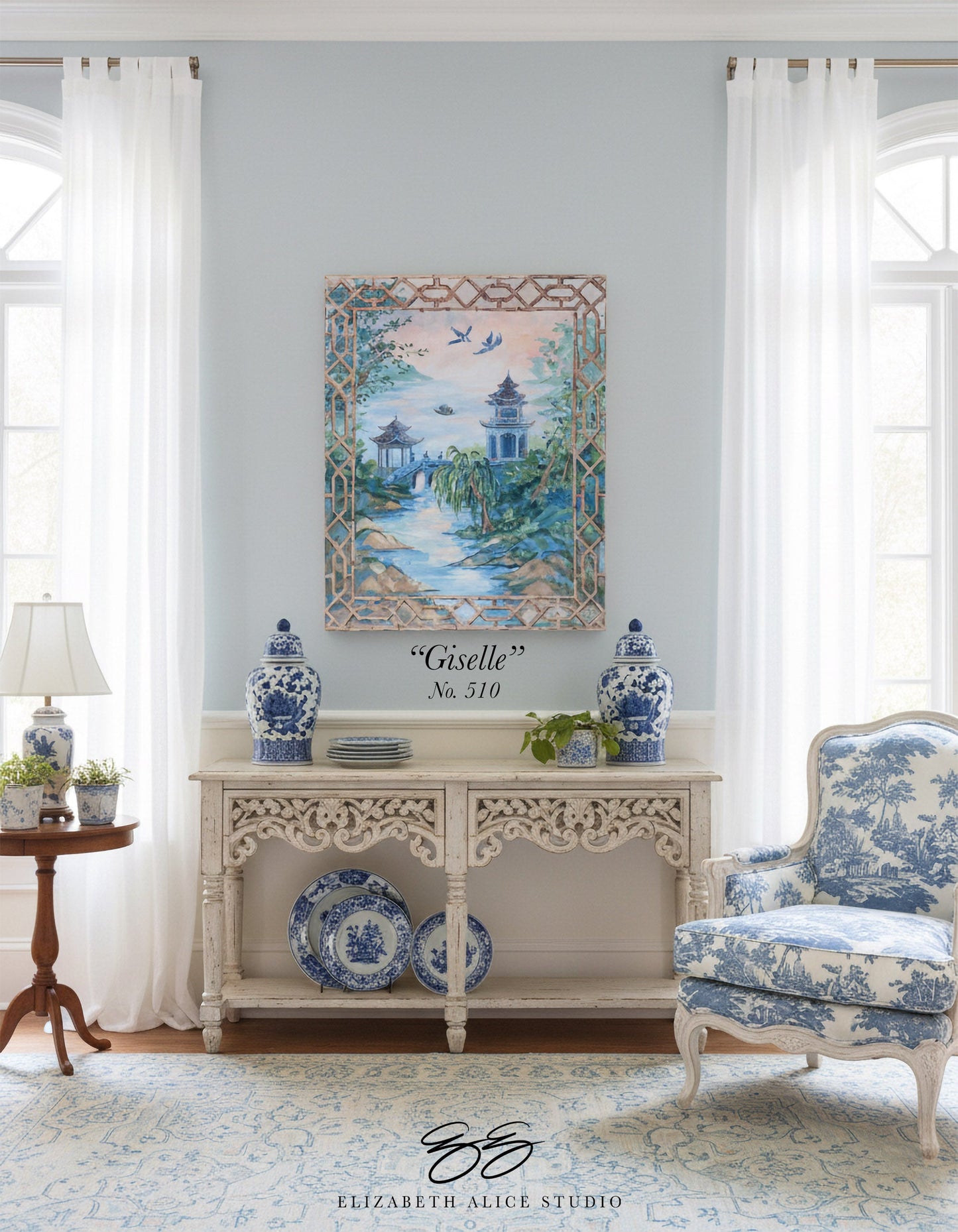 Elegant living room featuring Elizabeth Alice Studio blue and white decor, ornate console table, and patterned armchair.