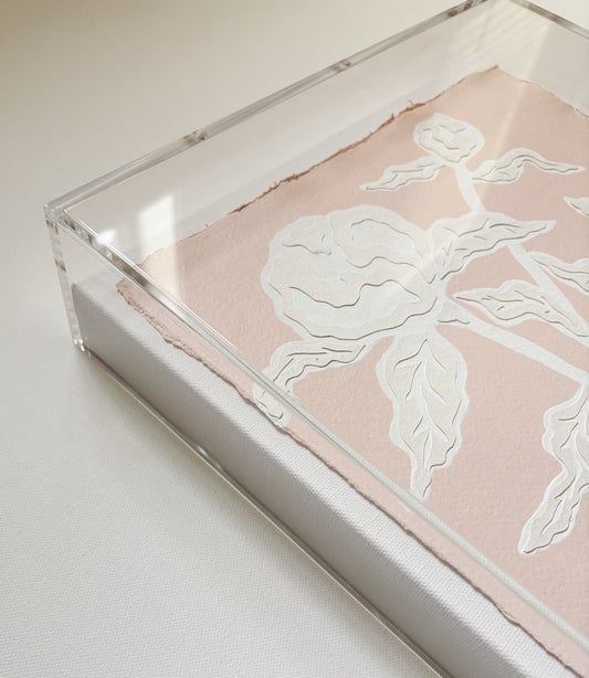 A botanical collage of pressed flowers by Kendal Blanchard Art in an acrylic box frame on cotton rag paper.