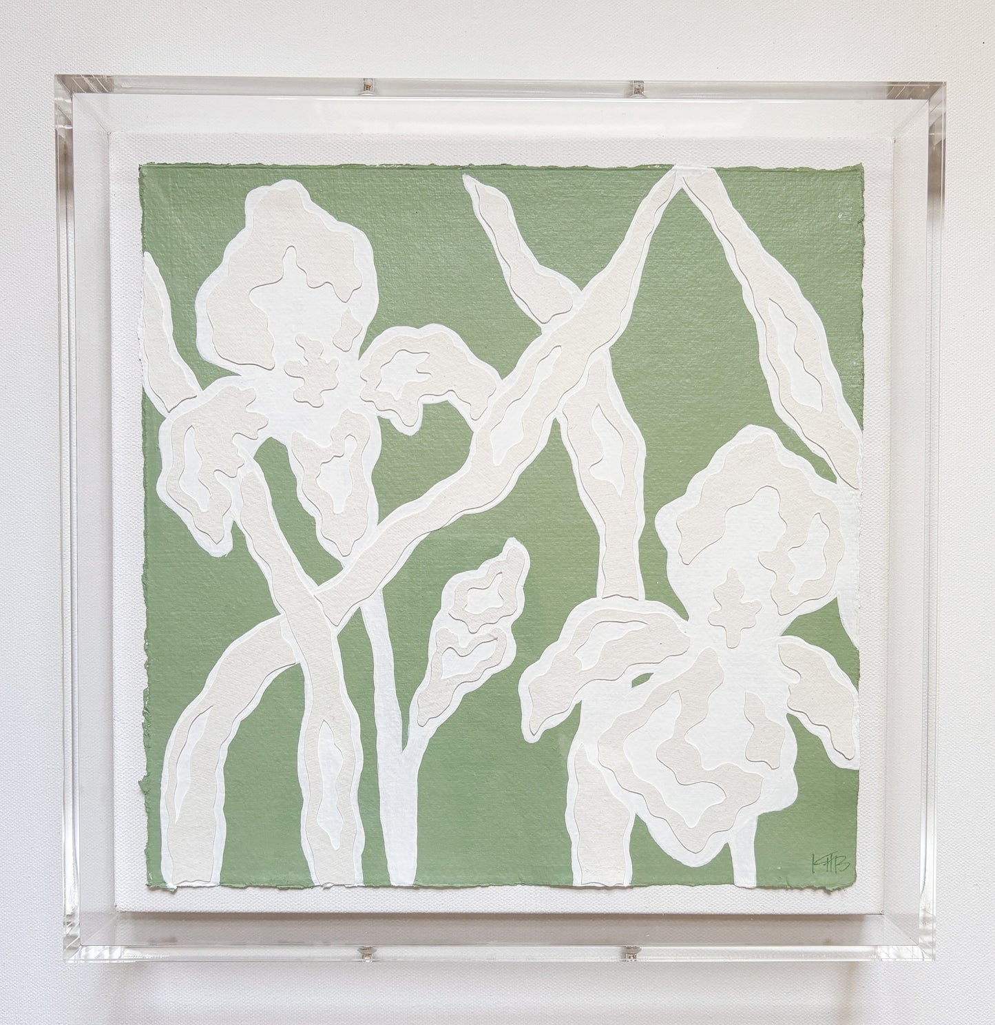 White abstract iris flowers on sage green by Kendal Blanchard Art, in clear acrylic frame with botanical collage details.