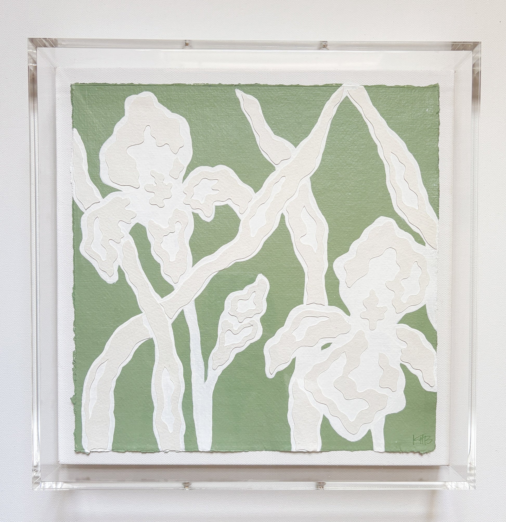 White abstract iris flowers on sage green by Kendal Blanchard Art, in clear acrylic frame with botanical collage details.