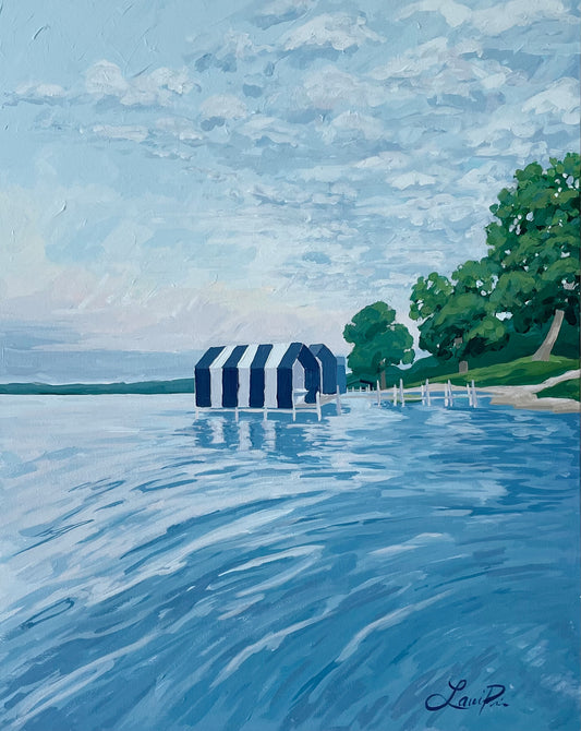 Lauri Prins acrylic on canvas, 24x30—blue-striped boathouses on a calm lake with green trees and cloudy sky.