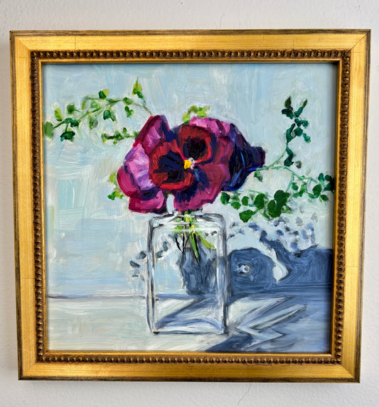 Catherine Husek framed wall art with vibrant pink flowers in a glass vase and green leaves on a light blue background.