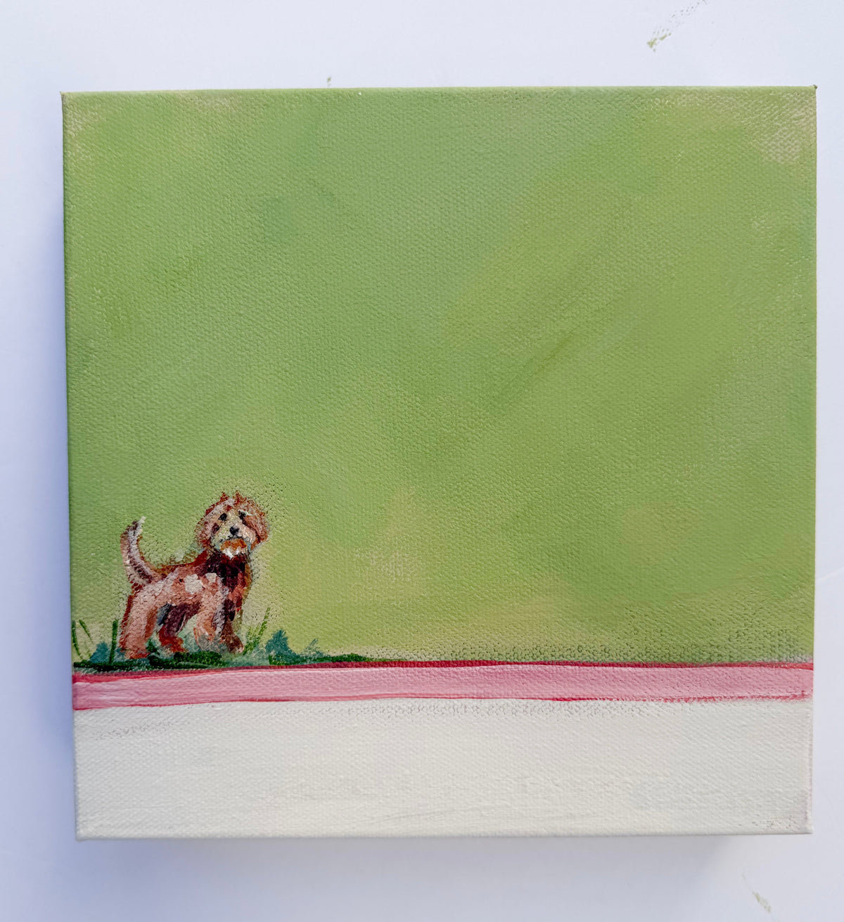 Small brown dog on a green background above a pink and white horizontal stripe in an original acrylic dog painting.
