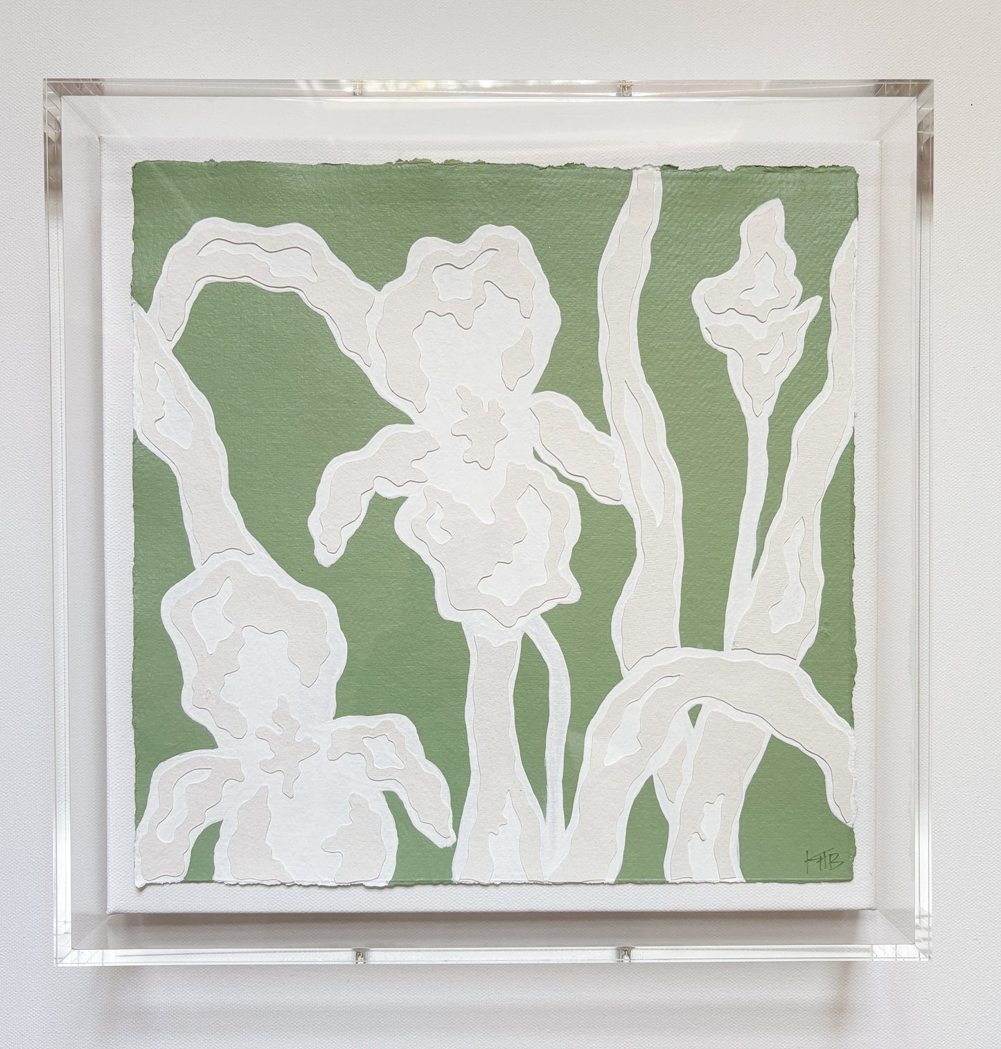 A textured green and white botanical collage of abstract iris flowers by Kendal Blanchard Art, in an acrylic box frame.