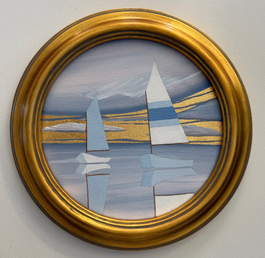 A circular 24K goldleaf painting of two sailboats on calm water against clouds and gold horizontal lines in a gold frame.