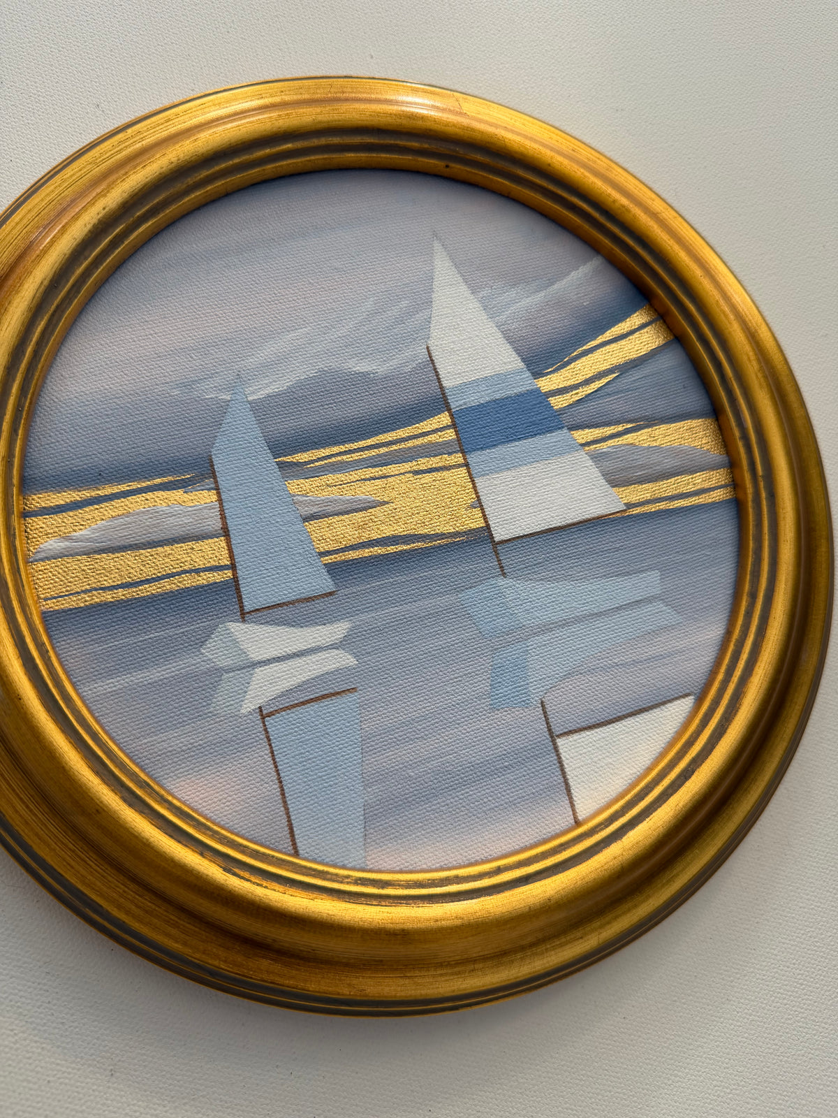 Circular 24K goldleaf painting of two stylized sailboats on water, with golden light reflecting in the coastal sky.