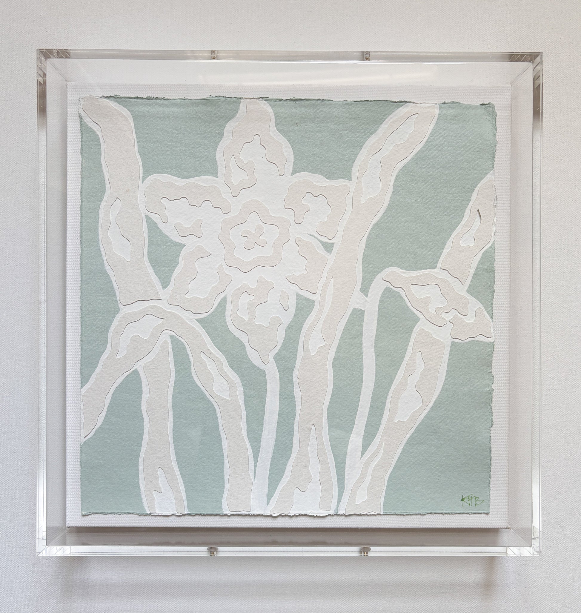 Kendal Blanchard Art handmade cotton rag paper collage of white daffodils on blue, in a clear acrylic box frame.