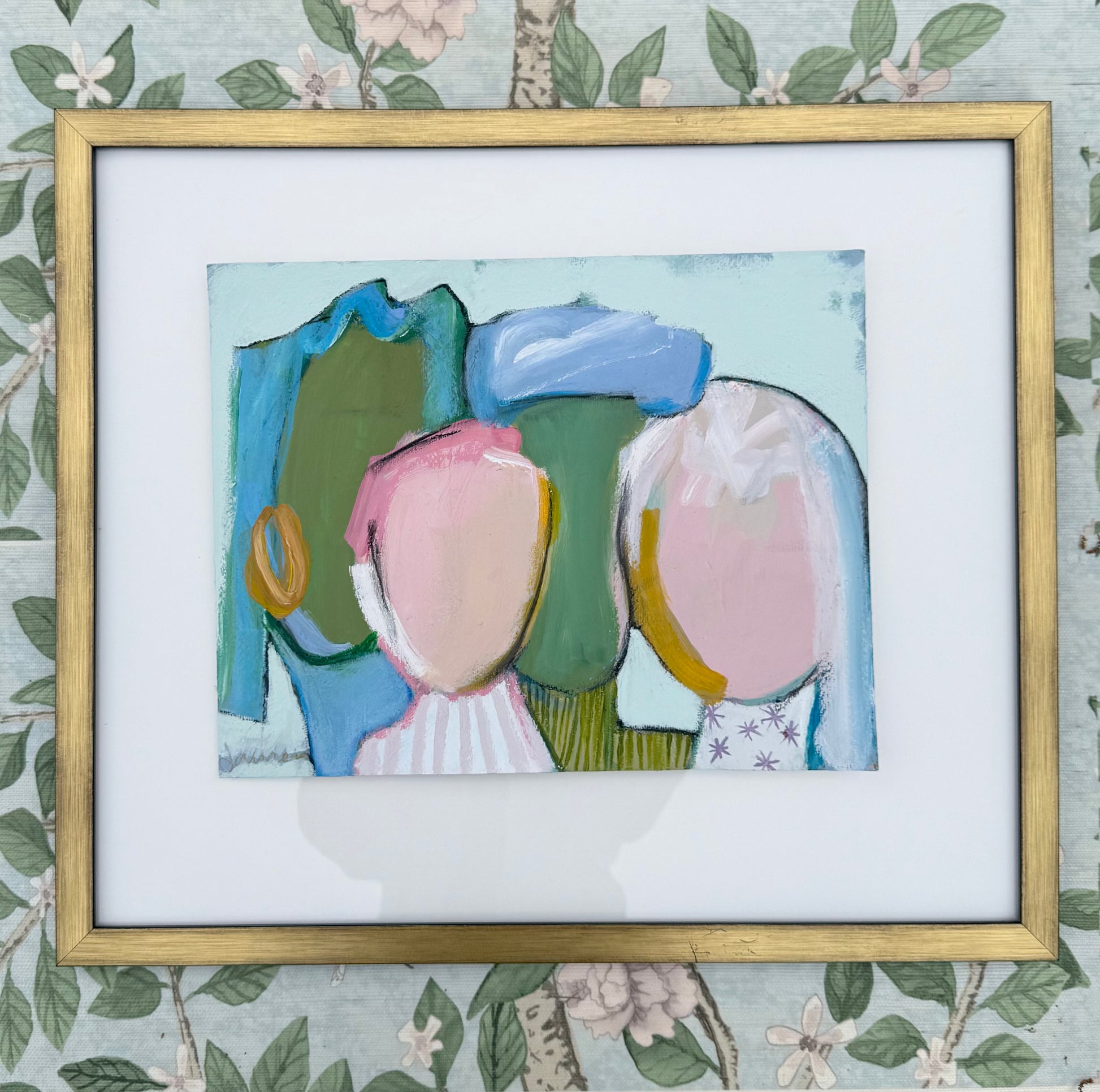 KP Art Collectives abstract mixed media art of three faceless figures in gold frame with a floral background.