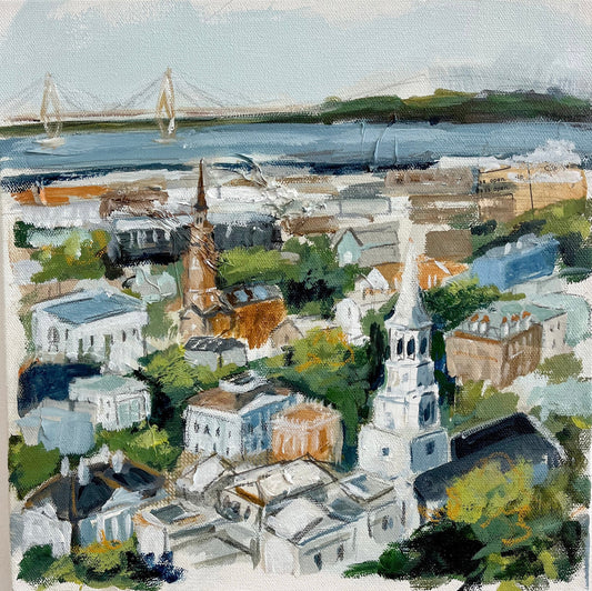 A colorful acrylic canvas by Christy Holmes of Charleston’s cityscape with churches, trees, buildings, and a bridge.