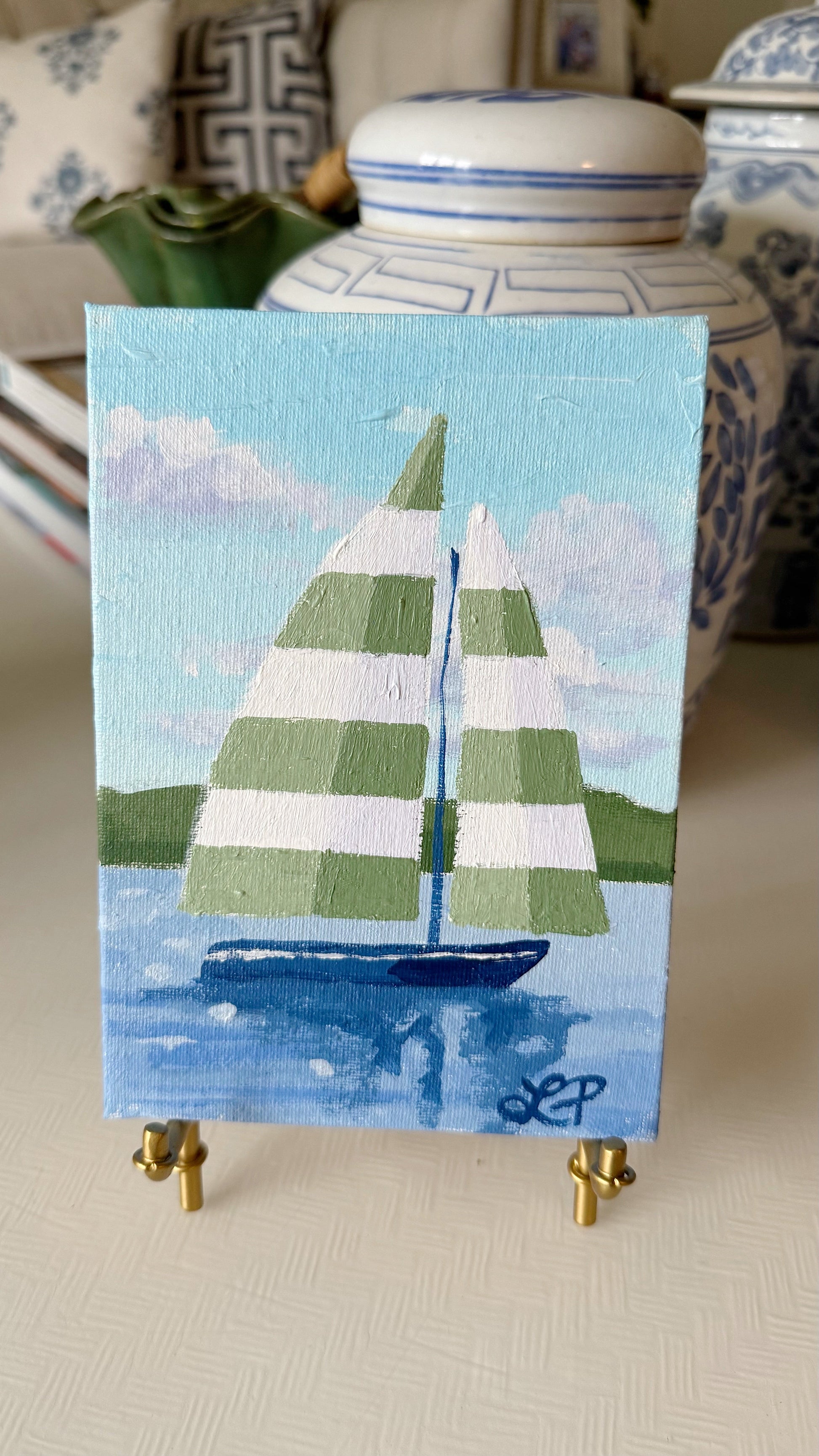 Lauri Prins original acrylic sailboat painting with striped sails on water, displayed on a mini indoor easel.