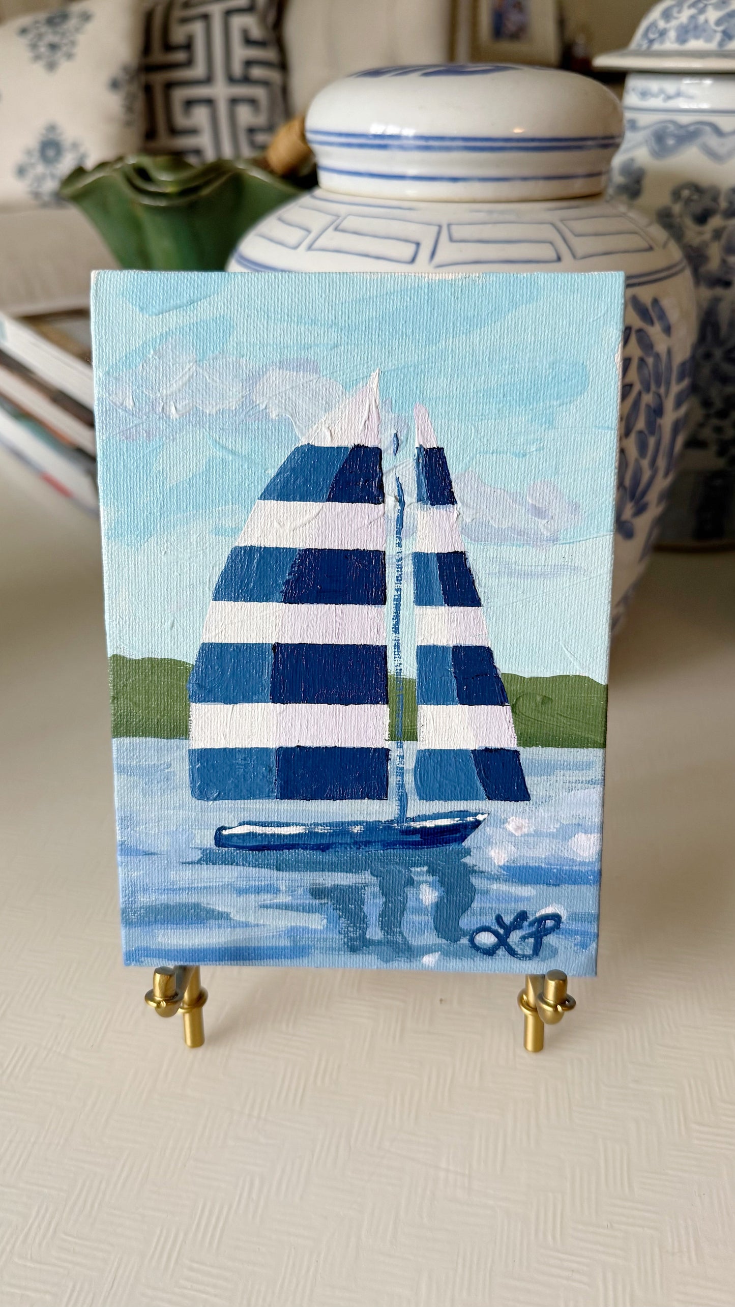 Lauri Prins small original acrylic painting of a sailboat with striped sails on calm water, on canvas board easel.
