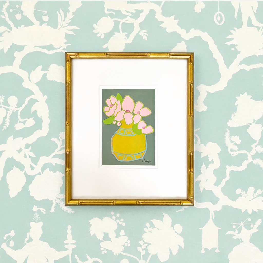 Kristin Cooney Studio: Framed chinoiserie art with pink flowers in a yellow vase, blue and white wallpaper backdrop.