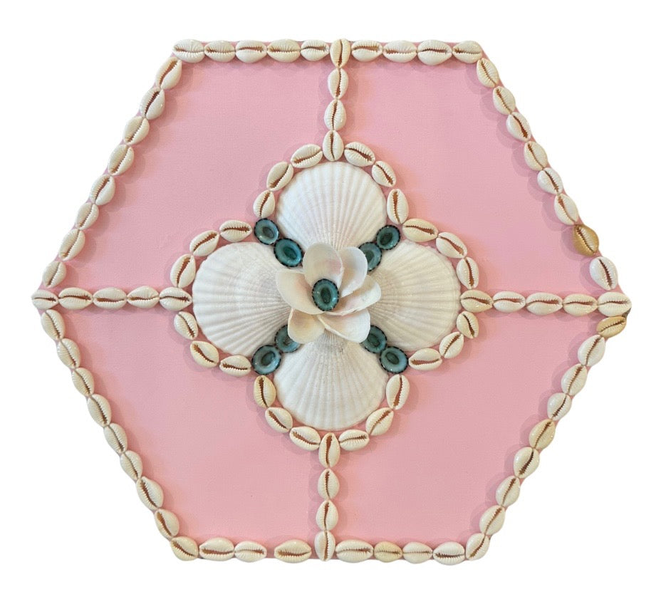 Kelsey Nichols Art shell design on pink hexagon wood panel features a seashell flower and cowrie shell border.