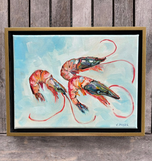 Three vibrant shrimp with long antennae on light blue, framed in gold. Art by Catherine Husek.