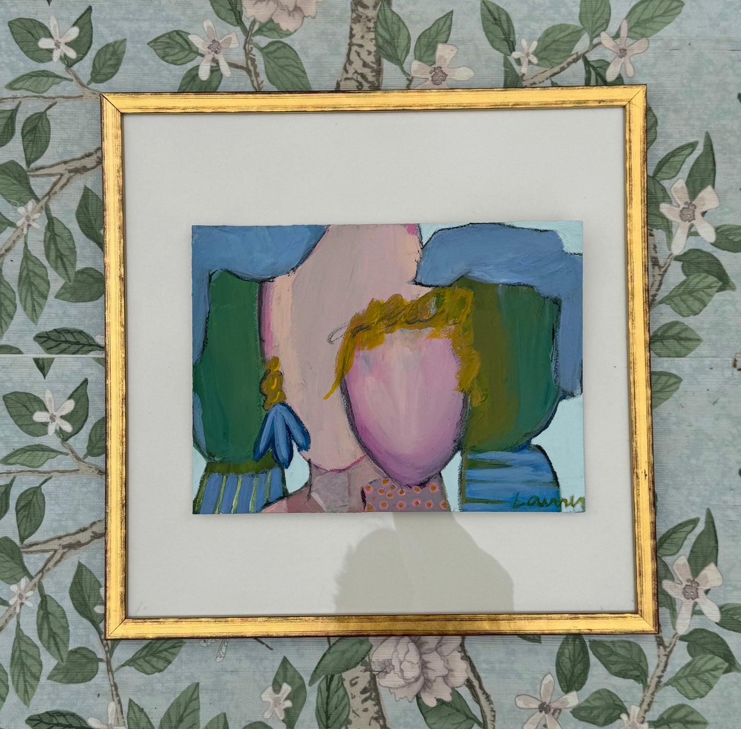 KP Art Collective framed mixed media art of a faceless figure with green shapes and floral wallpaper background.