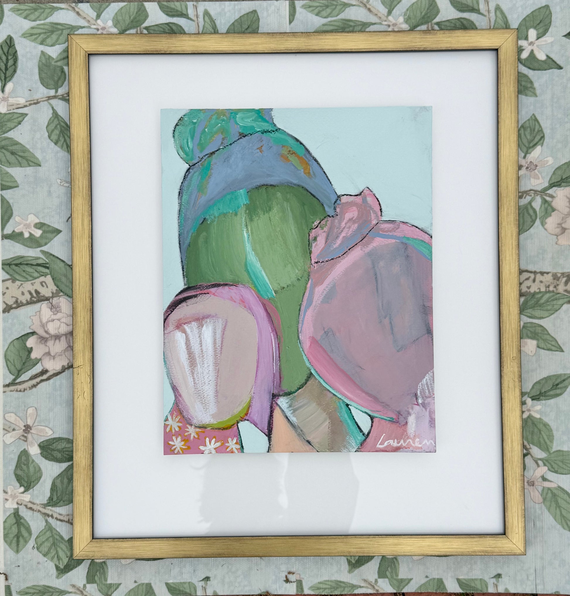 Framed mixed media artwork by KP Art Collective: three abstract figures in pastels on floral wallpaper background.