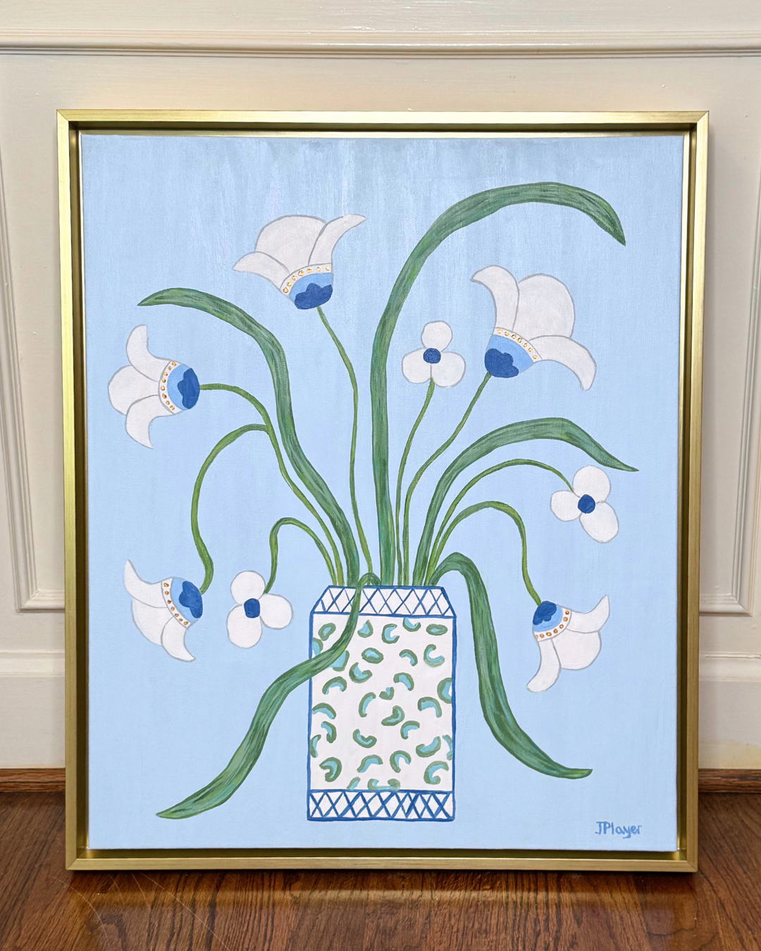 Original hand-painted artwork of white flowers with green stems in a patterned vase, framed in a gold float frame.