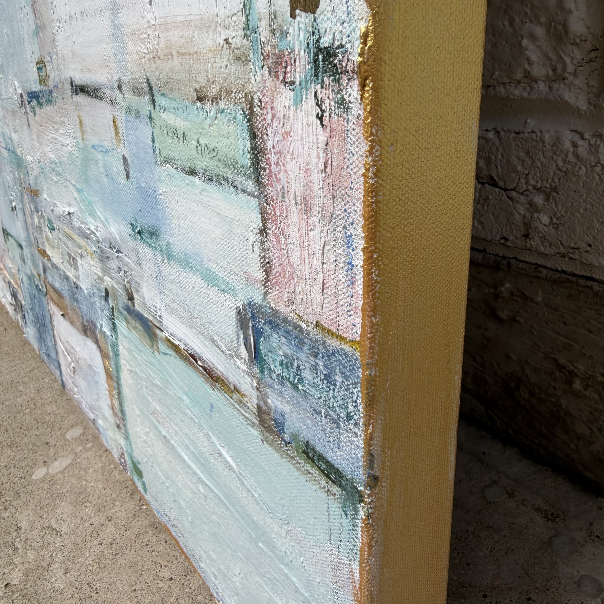 Close-up of the textured edge of a Megan Guidry abstract painting, inspired by glacial blue lakes and pastel tones.