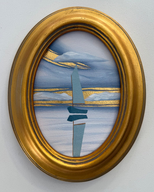 An oval goldleaf painting of a minimalist blue boat on water under gold-painted clouds, housed in a gold frame.