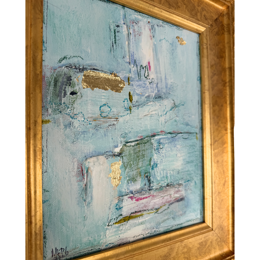 Framed art by Megan Guidry with gold leaf and blue, white, and pink strokes inspired by glacial lakes.