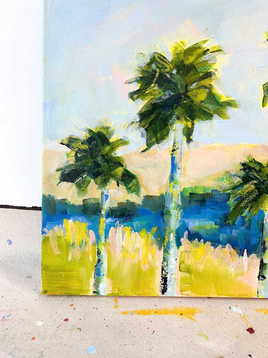 Abstract coastal painting of three palm trees with green leaves, blue trunks, and grassy landscape under a light blue sky.