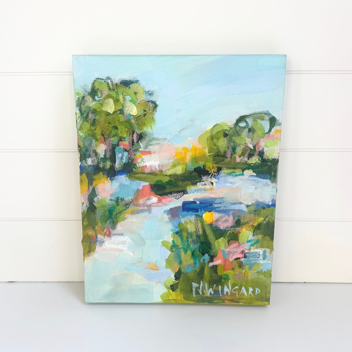Pamela Wingard Fine Art’s Vacation Groove painting features vibrant trees, water, and greenery beneath a light blue sky.