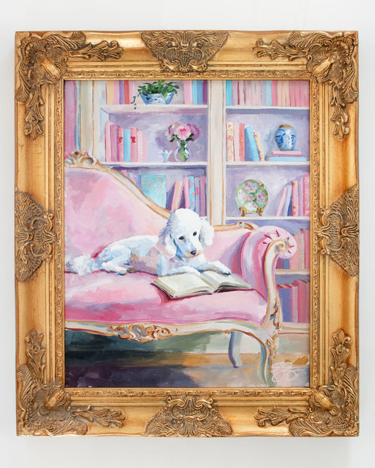 Elizabeth Alice: A white poodle reads on a pink sofa, with bookshelves and flowers, in a gold ornate frame.