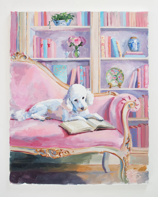 A white poodle lounges on a pink sofa, book open; vibrant bookshelves behind in this Elizabeth Alice dog art.