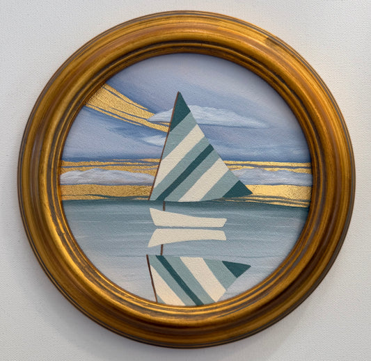 A circular coastal artwork of a sailboat with striped sails and its reflection on the water, accented with 24K gold leaf.