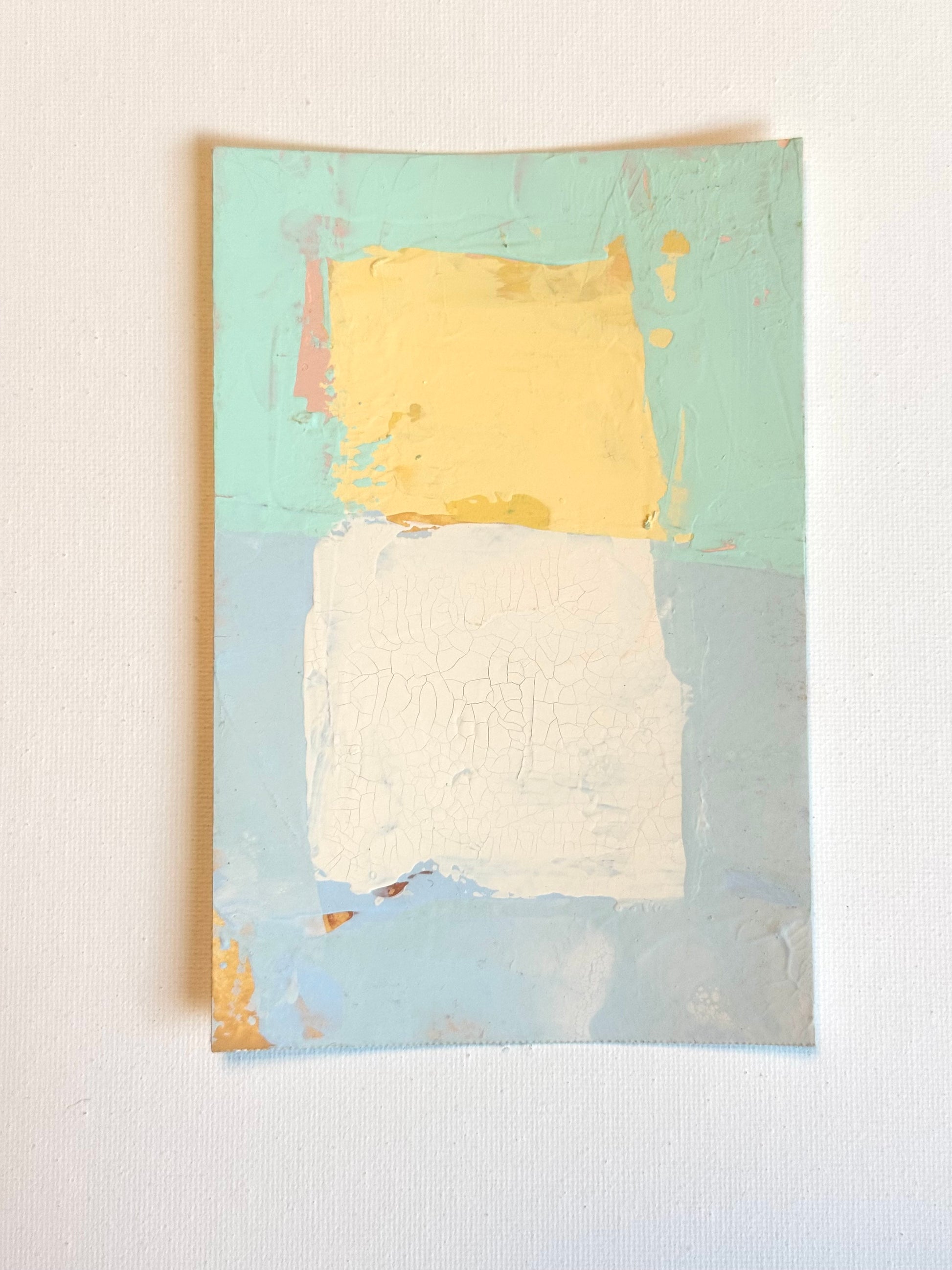 KP Art Collectives minimalist wall art shows a yellow block over white on a sunwashed blue-green background.