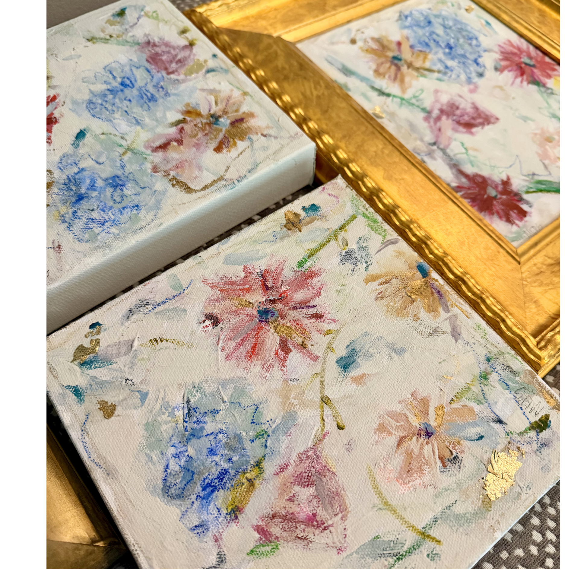 From Megan Guidry, this framed flower art features pastel blooms and gold leaf details for a stylish table display.